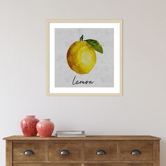 a framed photograph of an orange with the word lemon on it