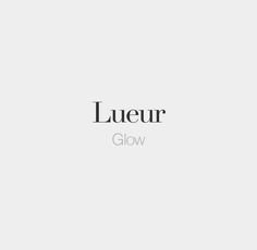 the word lueur glow in black and white on a light gray background with an image of