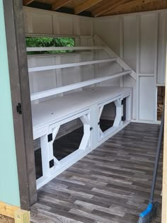 the inside of a chicken coop with its doors open