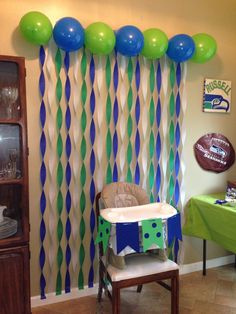 a baby's room decorated with balloons and streamers