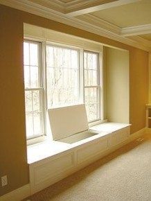 an empty room with a laptop on the window sill, and no one in it