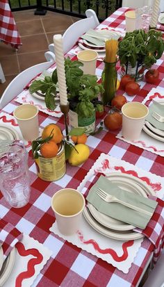 a red and white checkered table cloth with place settings