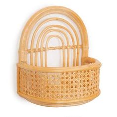 a small bamboo basket with a handle on the top and bottom, in front of a white background