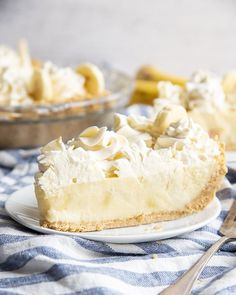 a piece of pie on a plate with a fork next to it and another pie in the background