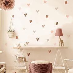 a room with hearts on the wall and a pink lamp in the corner next to it