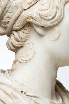 a close up of a statue of a woman's head