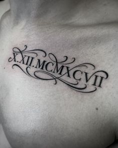 a chest tattoo with roman numerals and the word xxii mcmvt on it