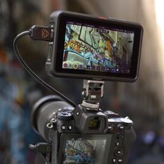 a video camera attached to a tripod with graffiti on it