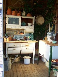 an old fashioned kitchen with lots of pots and pans