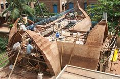 construction workers are working on the roof of a building