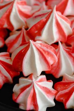 red and white peppermint meringues on a plate with text overlay