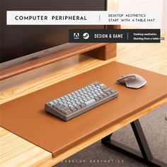 computer peripheral keyboard and mouse sitting on top of a wooden table next to a monitor