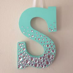 the letter s is decorated with sequins and beads