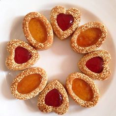 a white plate topped with peanut butter and jelly cookies