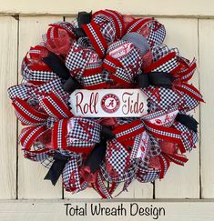 a red, white and black mesh wreath with the word roll tide on it that reads total wreath design