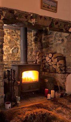 a wood burning stove in a stone walled room