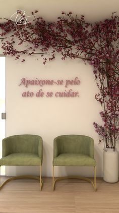 two green chairs sitting in front of a white wall with flowers on it and the words appartence - se pelo, ato de se enidar