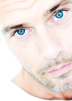 a close up of a man with blue eyes