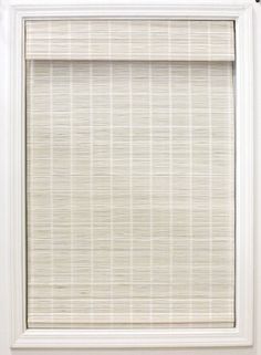 a white window with a bamboo blind in front of it and the blinds are closed