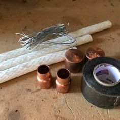 several rolls of duct tape sitting on top of a table next to some copper and white wires