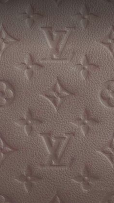 an upholstered leather surface with the word louis vuitton written on it