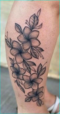 a black and white flower tattoo on the leg