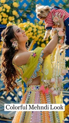 a woman holding a small dog in her arms with the caption colorful mehnic look