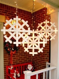 a christmas decoration with snowflakes hanging from the ceiling and decorations on the wall