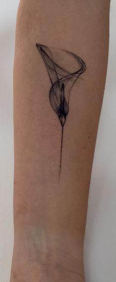 a woman's arm with a black and white tattoo design on the left side