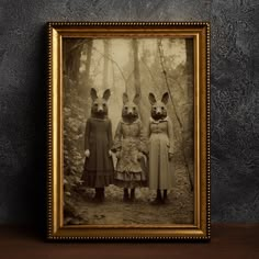 an old photo of three rabbits standing in the woods