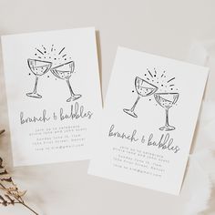 two wedding cards with champagne glasses on them