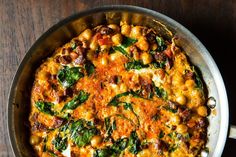 a pan filled with food on top of a wooden table