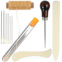 sewing supplies including needles, thread, and needle tips