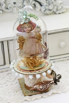 a glass clochet with french fries under it on a doily tablecloth