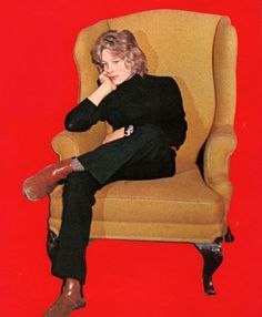 a woman sitting in a chair with her legs crossed