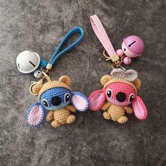 two crocheted keychains with small stuffed animals on them, one is pink and the other is blue