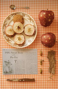 a plate with apples and cookies on it next to an article about the fox,