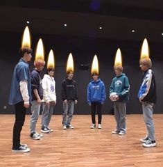 a group of young men standing on top of a wooden floor next to each other