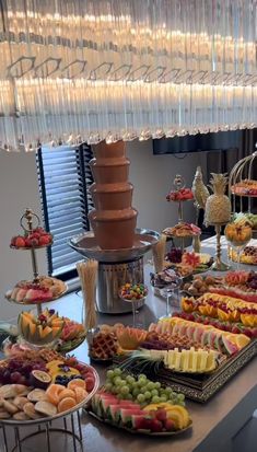 a buffet table filled with lots of different types of foods and desserts on it