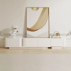 an art piece on top of a white entertainment center