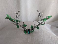 A gorgeous emerald woodland tiara featuring a silver moon and branches on either side. Your eyes will follow the rich green leaves surrounding the piece and onto the sparkling emerald crystal in the center. Choose between silver as pictured or bronze! Twig Crown, Silver Centerpiece, Green Moon