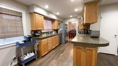 a kitchen with wooden cabinets and stainless steel appliances