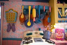 colorful kitchen utensils hanging on the wall