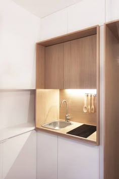 a kitchen with wooden cabinets and white walls