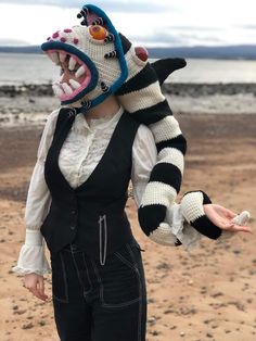 a woman wearing a costume made to look like a raccoon with its mouth open