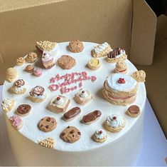 a birthday cake decorated with cookies and other treats