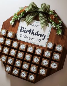 a happy birthday sign made out of chocolates and decorated with green bows on top