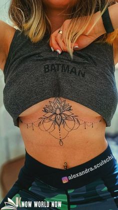 a woman with a flower tattoo on her stomach