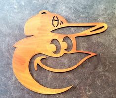 a wooden cutout of a smiling duck