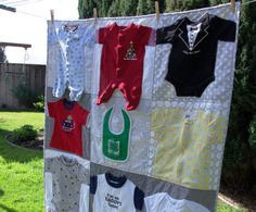 a baby's clothes hanging on a clothesline outside